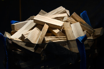 Bag filled with logs illuminated at shopping window. Photo taken December 8th, 2021, Zurich, Switzerland.