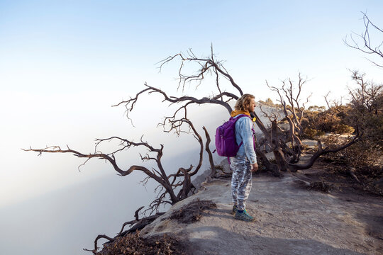 Man with respirator masks standing at the edge of volcano Ijen, Java, Indonesia