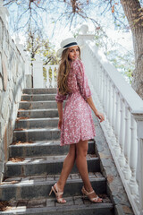 portrait of a beautiful delicate blonde woman in a summer pink dress