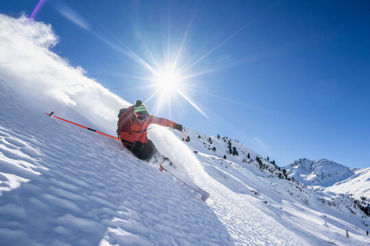 Sun shining over man skiing inArlbergmassif