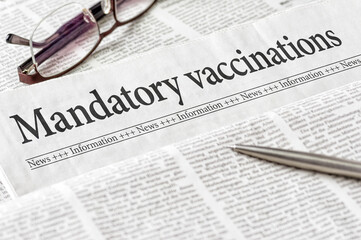 A newspaper with the headline Mandatory vaccination