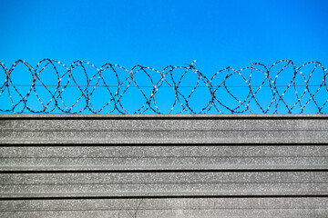 Way to freedom. Freedom blue sky behind the barbed wire fence