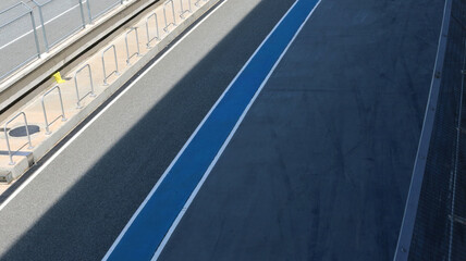 Asphalt track pit stop lane in racing circuit.	