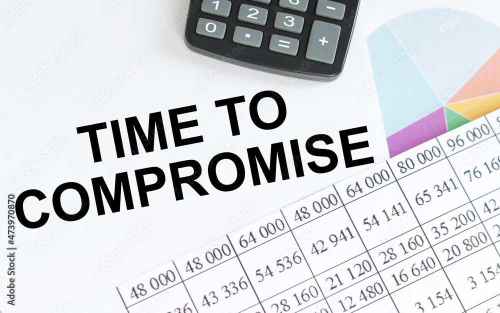 Poster on notepad text time to compromise, next to the calculator, pen, graphs and reports.