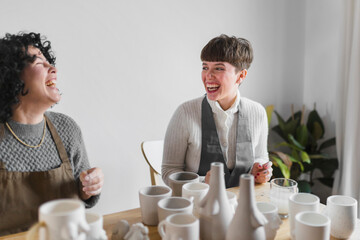 Happy female experts working at workshop