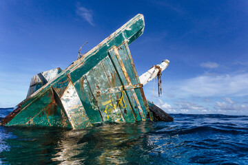Old abandoned ship floating on water in sea