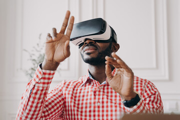 Black man in VR glasses experiencing 3D technology of augmented reality