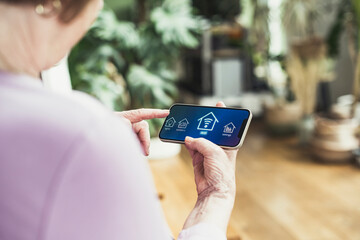Woman connecting smart phone with wifi at home
