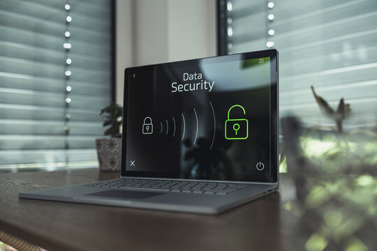 Laptop with data security icons on table at home
