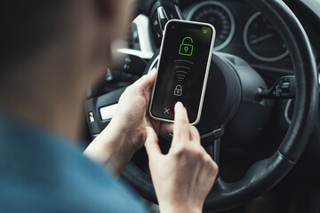 Woman unlocking mobile phone in car