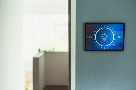 Home automation with light bulb icon on screen mounted on wall at home