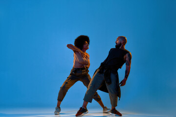 Flexible young man and woman dancing hip hop dance