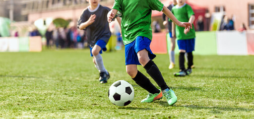 Group of chool Kids Running Football Ball and Compete in School Soccer Tournament. Boys in Sports...