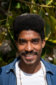 Smiling man with mustache during sunny day