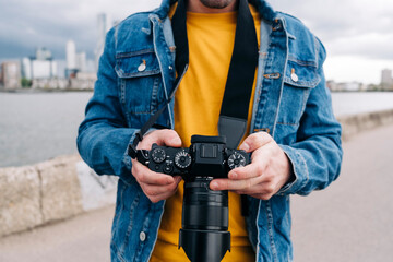 Young man operating camera on promenade