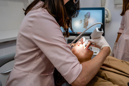 Female dentist checking patient in clinic