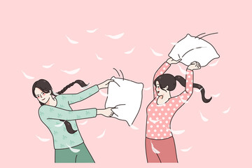 Happy girlfriends have fun beat with pillows at pajama party at home. Smiling girls feel crazy with pillow fight at domestic sleepover on weekend. Friendship concept. Flat vector illustration. 