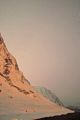 nights picture of the sky full of stars with mountain and ocean