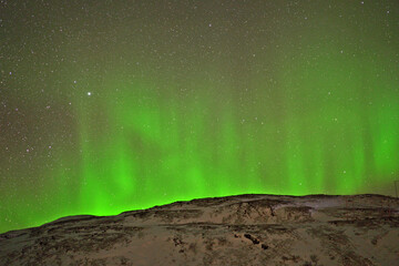 northern lights on the sky above the mountain in Norway