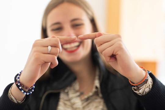 Smiling woman playing with finger