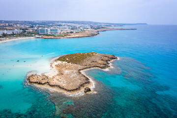 Aerial view of the most famous beaches in Cyprus - Nissi Beach. White sand beach with azure waters. Beautiful beach and panoramic views of Cyprus
