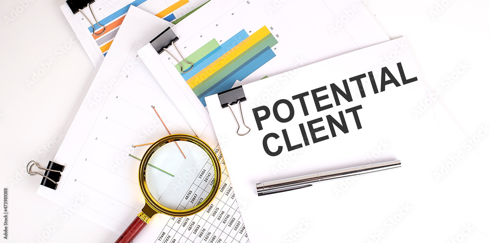 Poster potential client text on the white paper on light background with charts paper