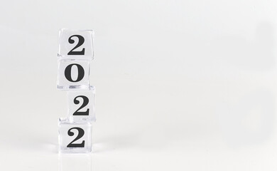 Happy New Year 2022 on ice cubes on white background,copy space