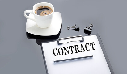 CONTRACT text on paper sheet with coffee on the black background