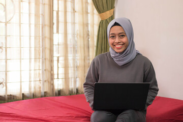 Asian women in hijab work from home