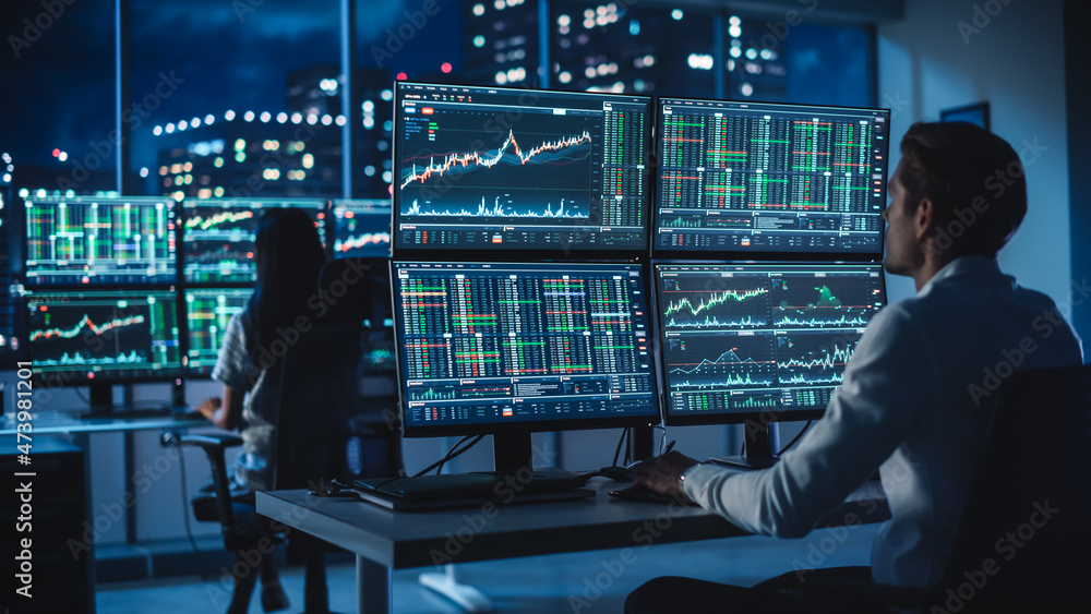 Poster financial analyst working on a computer with multi-monitor workstation with real-time stocks, commod