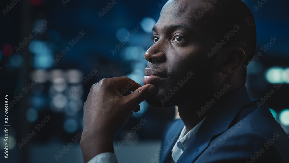 Aufkleber portrait of a financial project manager working on computer in an office late in the evening. africa