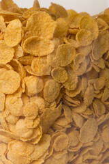 Fototapeta premium pile of cereal corn flakes background close up filled frame copy space wallpaper vertical shot