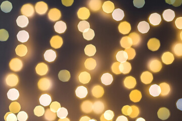 Festive blurred background of orange round lights on a dark backdrop. The perfect concept for a...