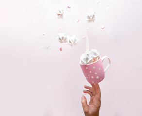 white meringue cookies flying over pink background. Levitation trend photo. Copy space. Sweet...