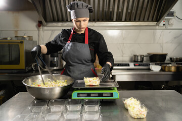 Food delivery, chef cooking charity lunch in plastic containers, small business takeaway food, weigh food on scales in restaurant, lunch delivery service