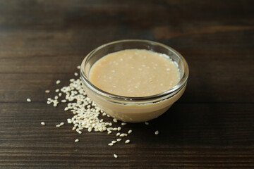 Concept of tasty food with tahini sauce on wooden background