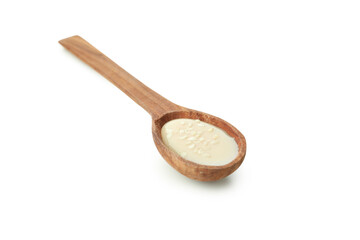 Tahini sauce in spoon isolated on white background