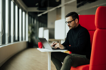 Serious caucasian man, focusing on his work in the company office.