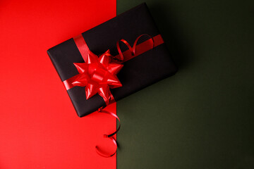 Black gift box with shiny red ribbons, Top view. Holiday decoration element. Birthday or...
