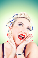 Stereotypical Housewife with hair curlers and surprised expression.