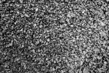 Asphalt road closeup in black and white.