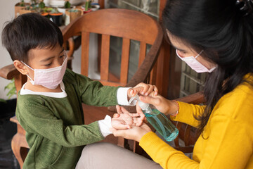 a mother uses antiseptics for her son at home