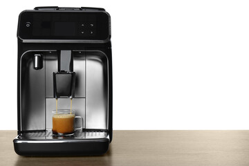 Modern espresso machine pouring coffee into glass cup on wooden table against white background....
