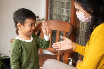 Social distance. Asian boys refuse to shake hands