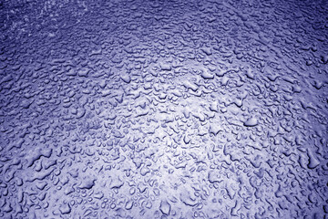 Water drops on metal surface in blue tone.