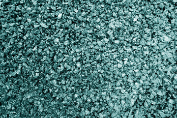 Asphalt road closeup in cyan tone.