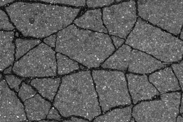 Broken asphalt texture in black and white.