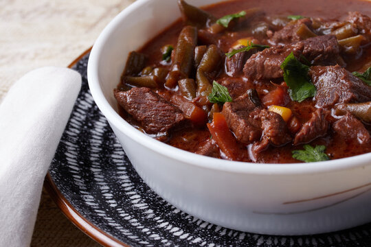 Homemade beef casserole garnished with herbs.