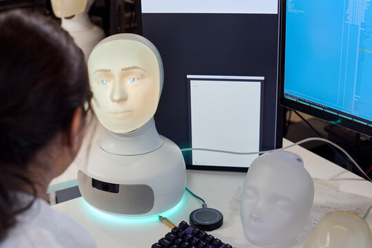 Female engineer working on robot