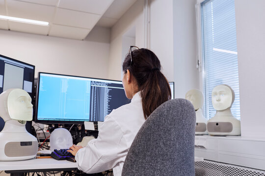 Female engineer sitting at work station